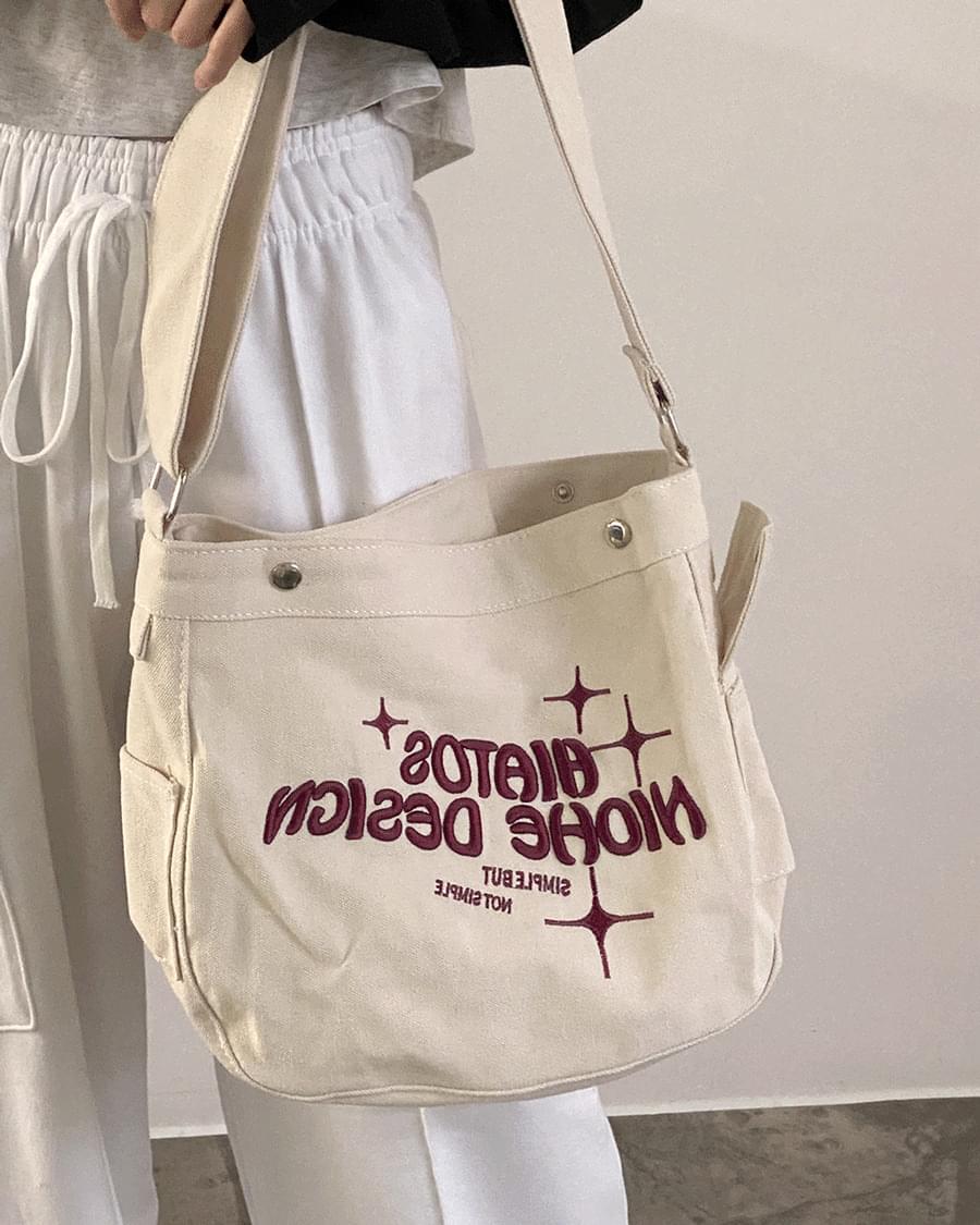 Haia embroidered cotton-canvas cross-body messenger bag
